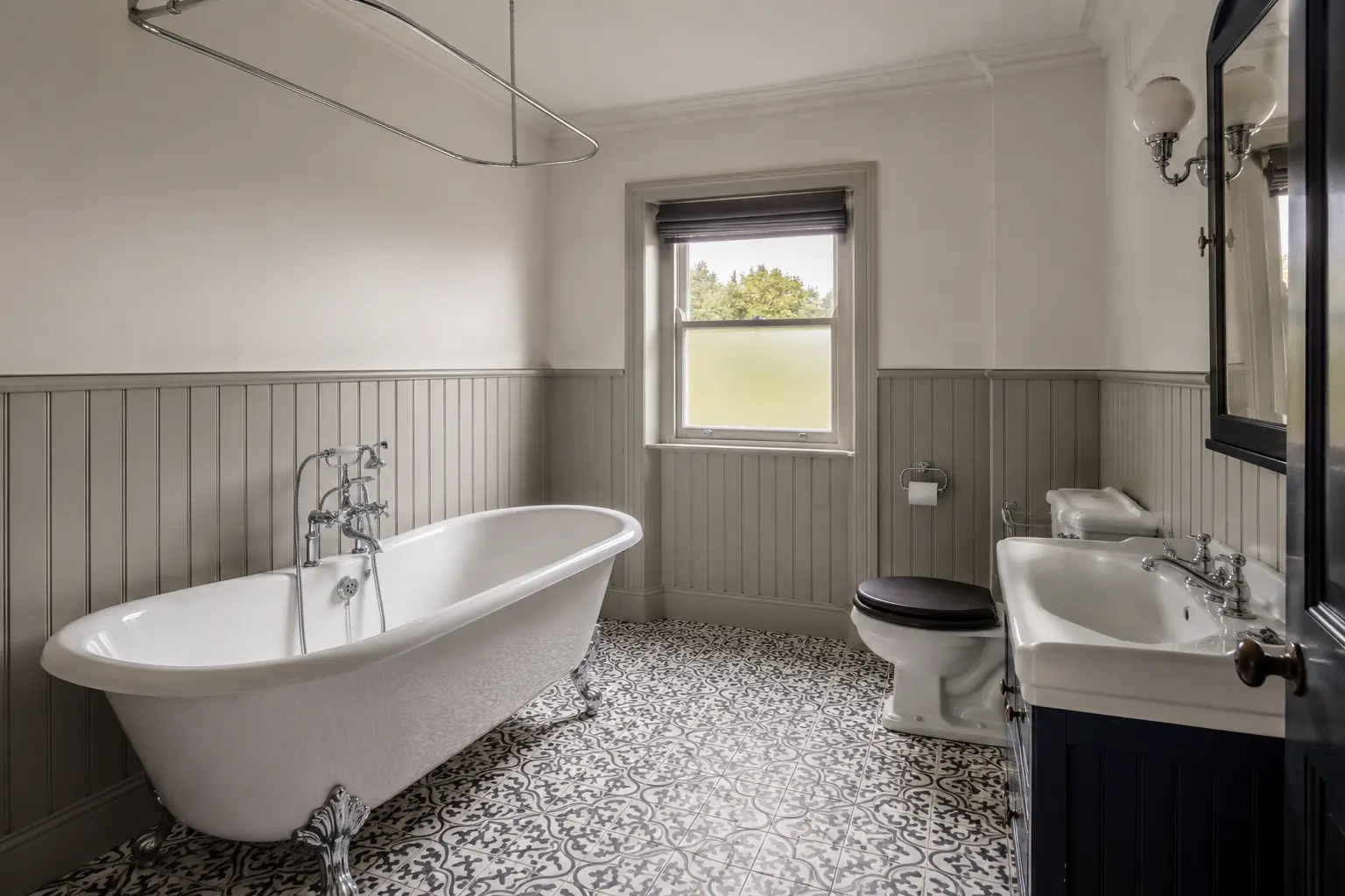 Traditional green bathroom with freestanding bath